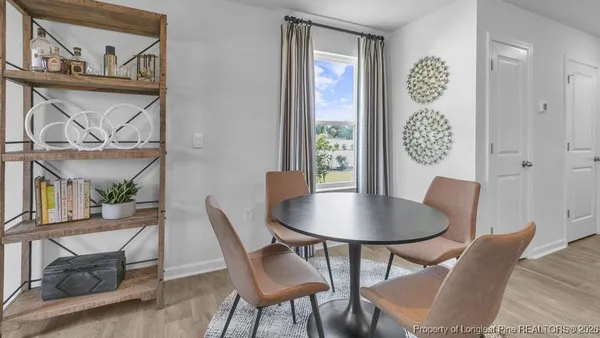 a dining room with furniture and window
