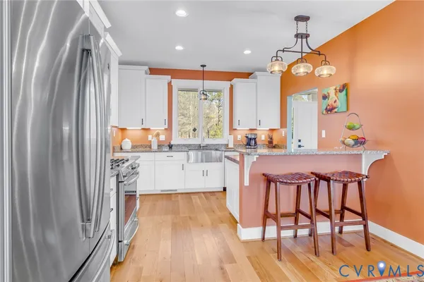 a large kitchen with a table and chairs