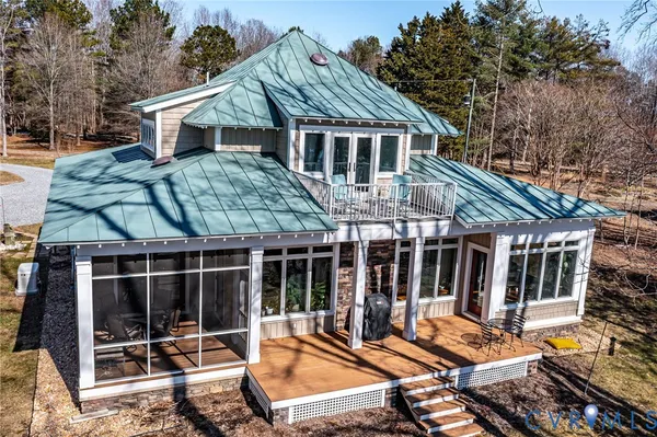 a view of a house with backyard porch and sitting area
