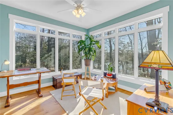a living room with patio furniture and a floor to ceiling window