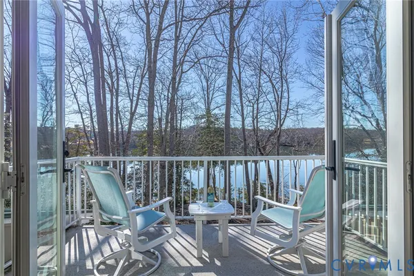 a view of a chair and table on the deck