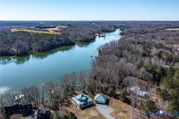 an aerial view of house with yard and lake view
