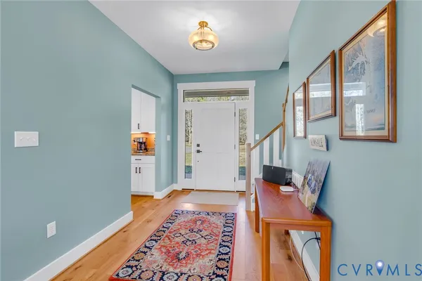 a view of an entryway with wooden floor