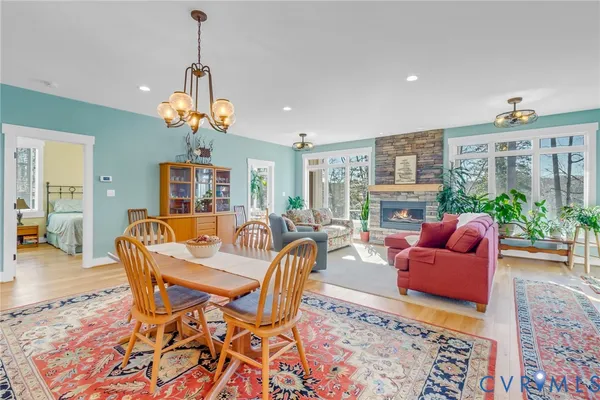 a living room with furniture a fireplace and a chandelier