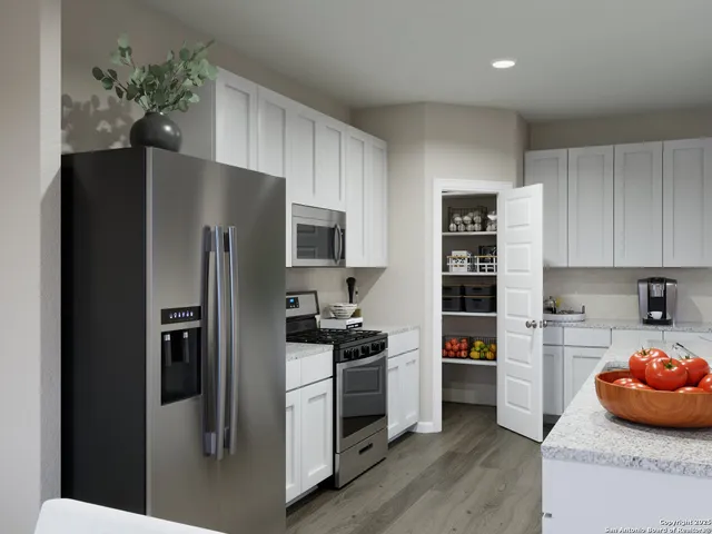 a kitchen with a stove and a refrigerator