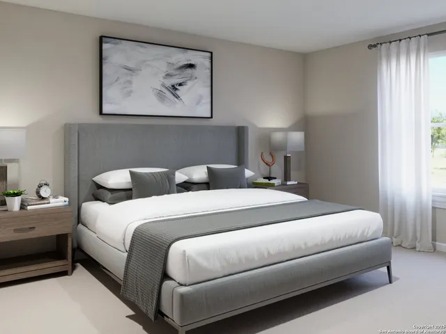 a living room with a bed furniture and a flat screen tv