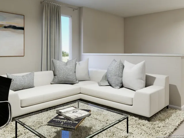 a living room with furniture a potted plant and a wooden floor