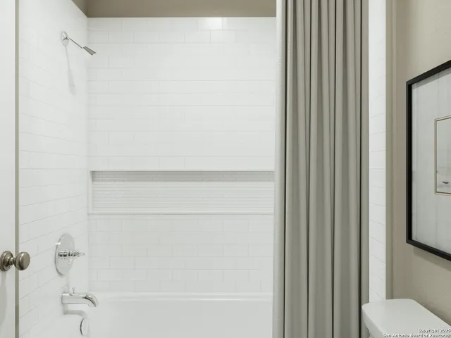 a large bed sitting in a bedroom next to a cabinet