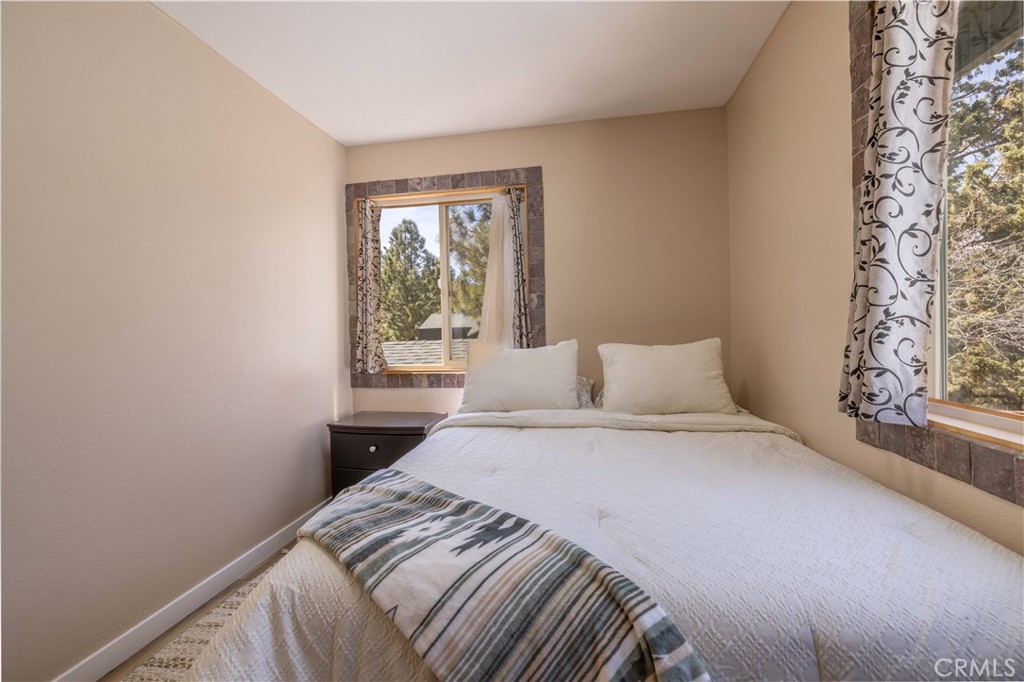 196 Sunset Lane Sugarloaf, CA 92386 - Photo 13 of 26 a bedroom with a bed and a window