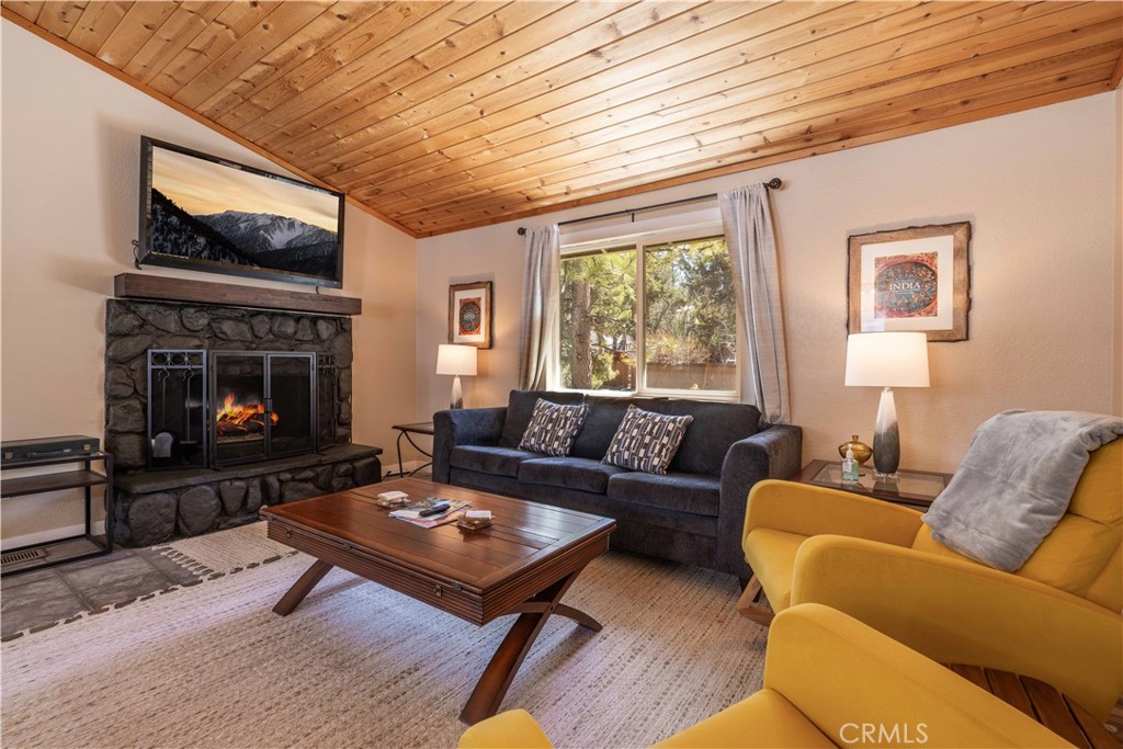 196 Sunset Lane Sugarloaf, CA 92386 - Photo 2 of 26 a living room with furniture a flat screen tv and a fireplace