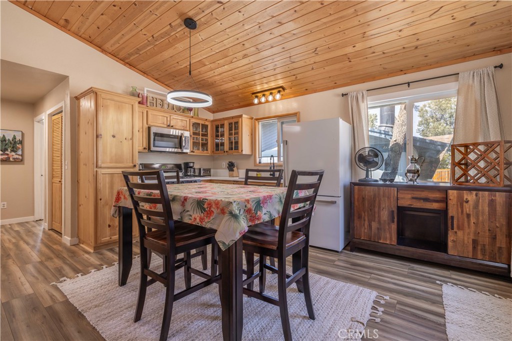 196 Sunset Lane Sugarloaf, CA 92386 - Photo 3 of 26 a view of a dining room with furniture window and wooden floor