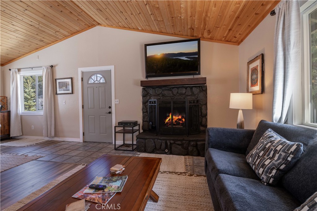 196 Sunset Lane Sugarloaf, CA 92386 - Photo 8 of 26 a living room with furniture a flat screen tv and a fireplace