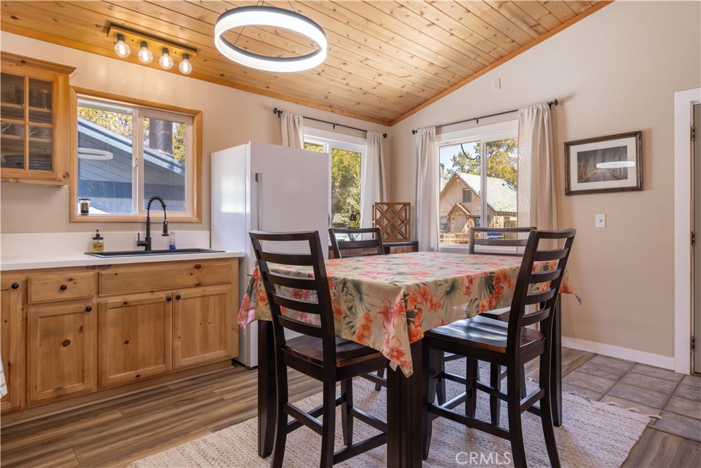 196 Sunset Lane Sugarloaf, CA 92386 - Photo 9 of 26 a dining room with stainless steel appliances granite countertop a dining table and chairs with wooden floor