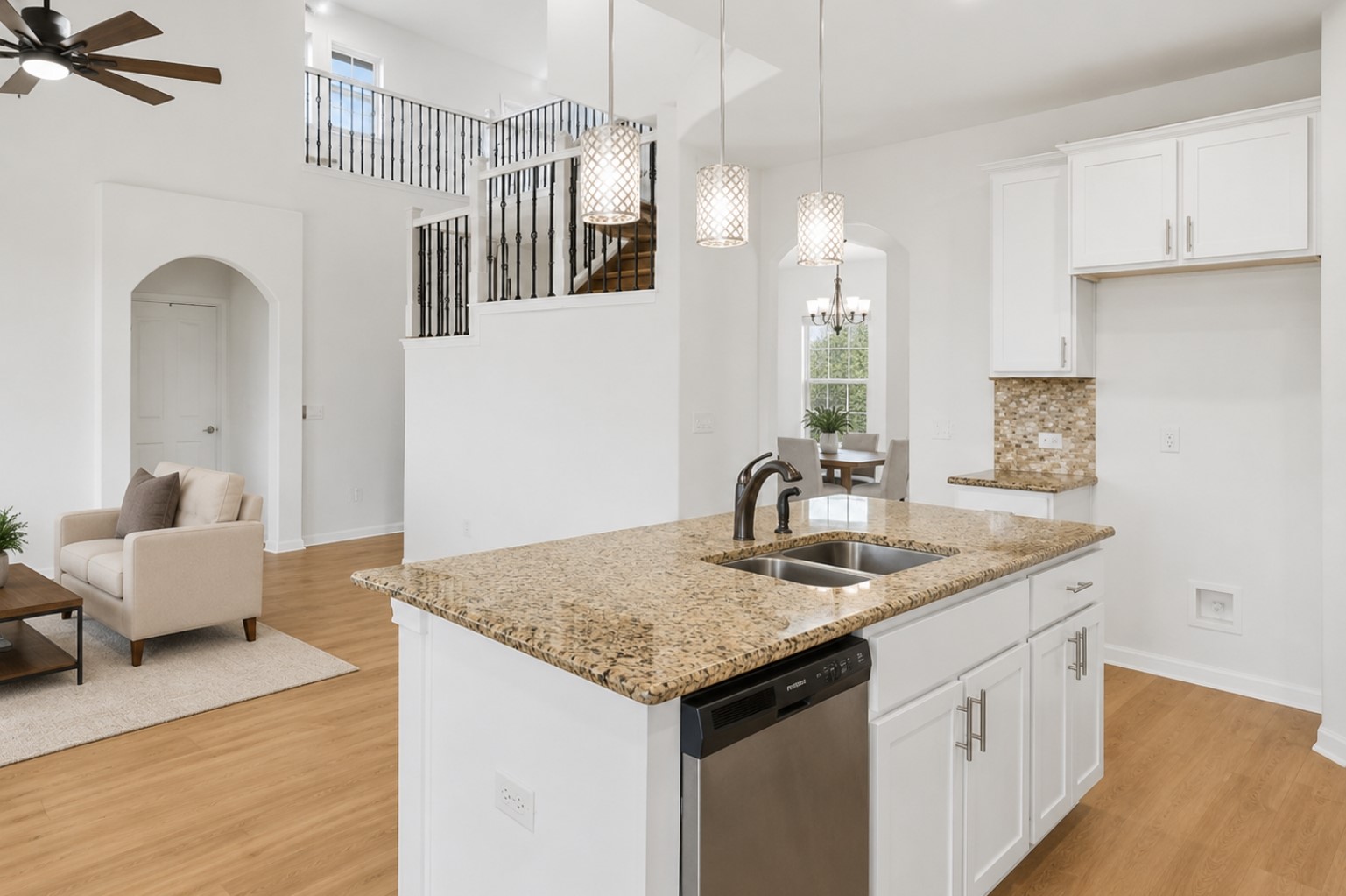 304 Santa Maria Street Georgetown, TX 78628 - Photo 7 of 37 An inviting open-concept layout connects a modern kitchen island with an elegant living area and grand staircase. Virtually Staged.