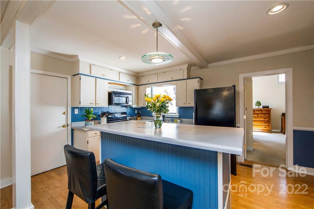 3200 Dublin Road Charlotte, NC 28208 - Photo 12 of 48 a kitchen with stainless steel appliances a dining table chairs and refrigerator