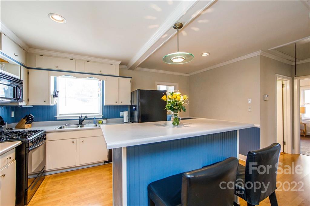 3200 Dublin Road Charlotte, NC 28208 - Photo 14 of 48 a kitchen with a sink a stove and chairs