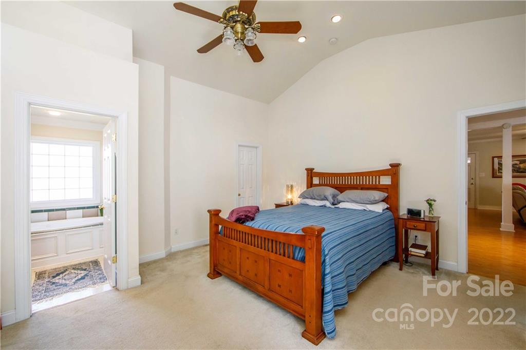 3200 Dublin Road Charlotte, NC 28208 - Photo 23 of 48 a bedroom with a bed and a chandelier