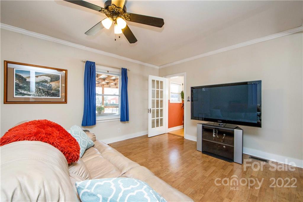 3200 Dublin Road Charlotte, NC 28208 - Photo 9 of 48 a living room with a flat screen tv and a chandelier