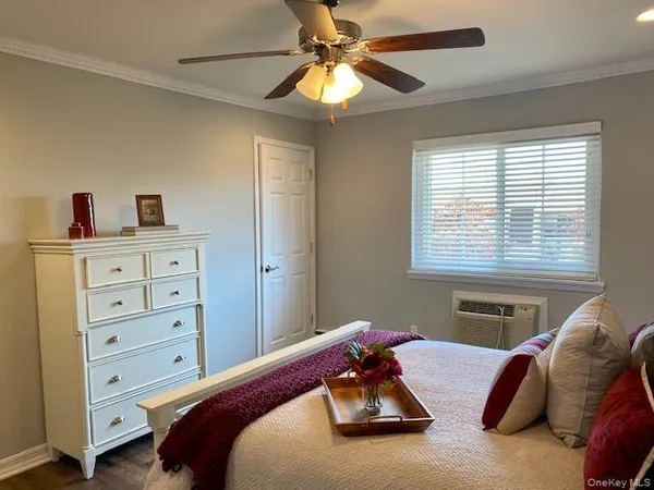 a bedroom with furniture and a window