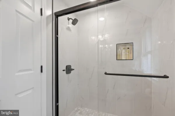 a bathroom with a glass shower door