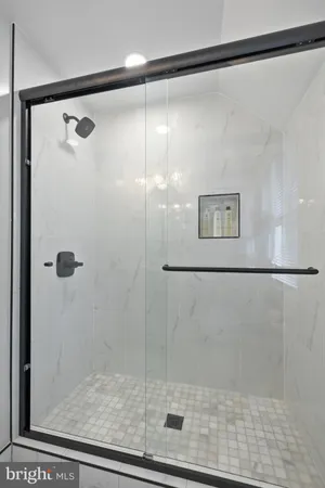 a bathroom with a glass shower door