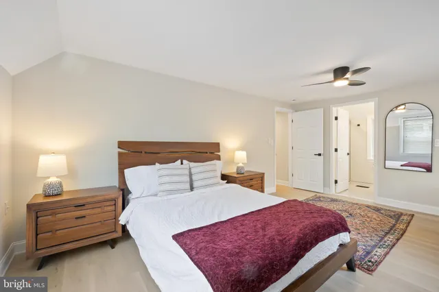 a bedroom with a bed and a night stand