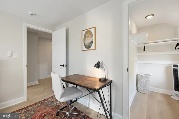 a view of a room with furniture and wooden floor