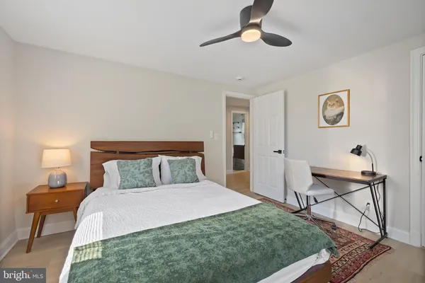 a bedroom with a bed and a lamp on table