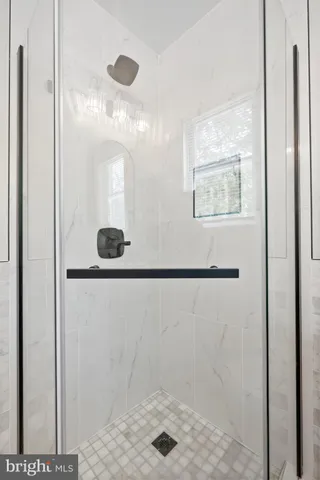 a bathroom with a shower and a sink