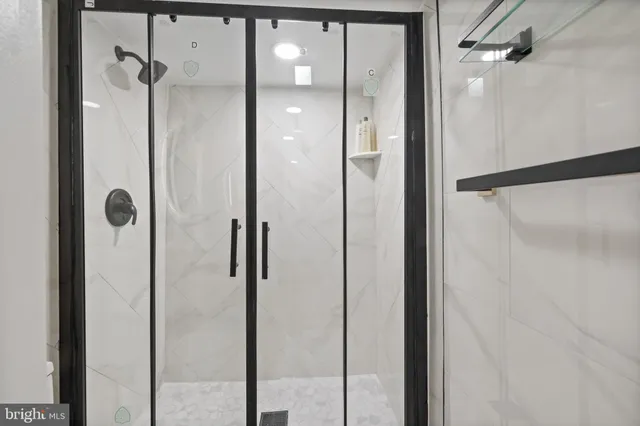 a bathroom with a glass shower door