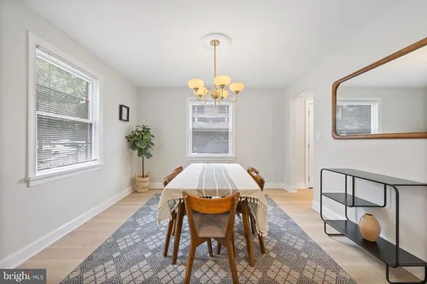a dining room with a table and a chandelier