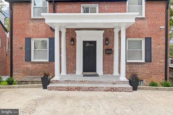 a front view of a house with a garden and entryway