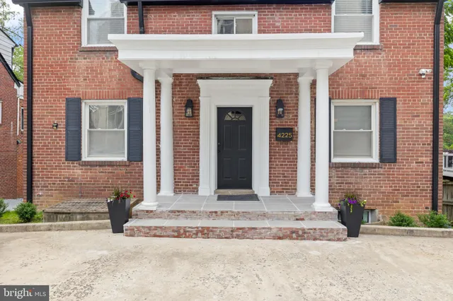 a front view of a house with a garden and entryway