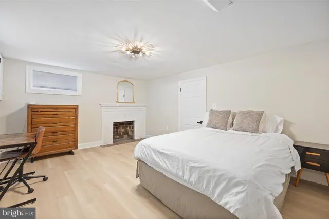 a spacious bedroom with a bed and a fireplace