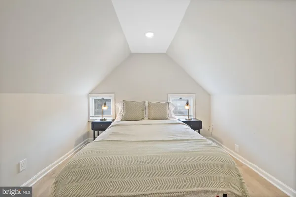 a bed room with a bed and a night stand