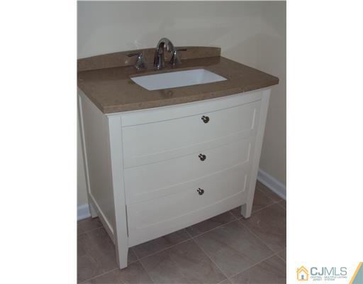 64 Helmetta Road Monroe Township, NJ 08831 - Photo 19 of 22 a bathroom with a sink and a mirror
