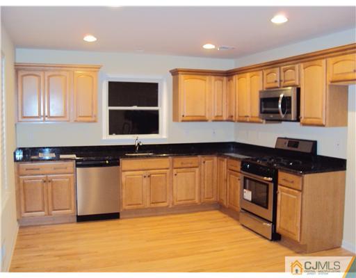 64 Helmetta Road Monroe Township, NJ 08831 - Photo 4 of 22 a kitchen with stainless steel appliances granite countertop a stove top oven a sink a counter space and cabinets