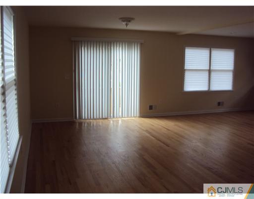 64 Helmetta Road Monroe Township, NJ 08831 - Photo 7 of 22 an empty room with wooden floor and windows