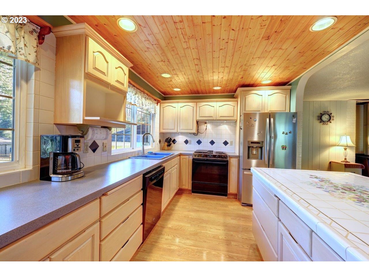 93066 Knappa Dock Road Astoria, OR 97103 - Photo 13 of 29 a kitchen with stainless steel appliances kitchen island granite countertop a sink refrigerator and cabinets