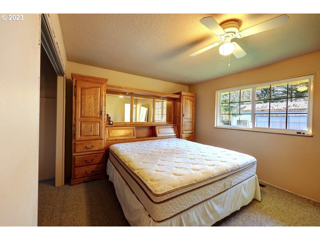 93066 Knappa Dock Road Astoria, OR 97103 - Photo 15 of 29 a bedroom with a bed and a dresser with mirror