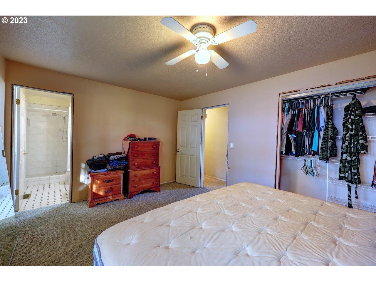 93066 Knappa Dock Road Astoria, OR 97103 - Photo 16 of 29 a bedroom with a bed and a chandelier