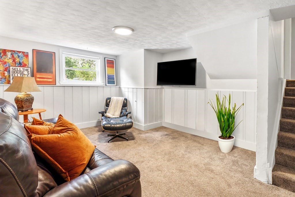 10 Colonial Road Hingham, MA 02043 - Photo 13 of 21 a living room with furniture and a flat screen tv