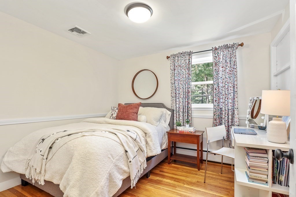 10 Colonial Road Hingham, MA 02043 - Photo 17 of 21 a bedroom with a bed a table and chair