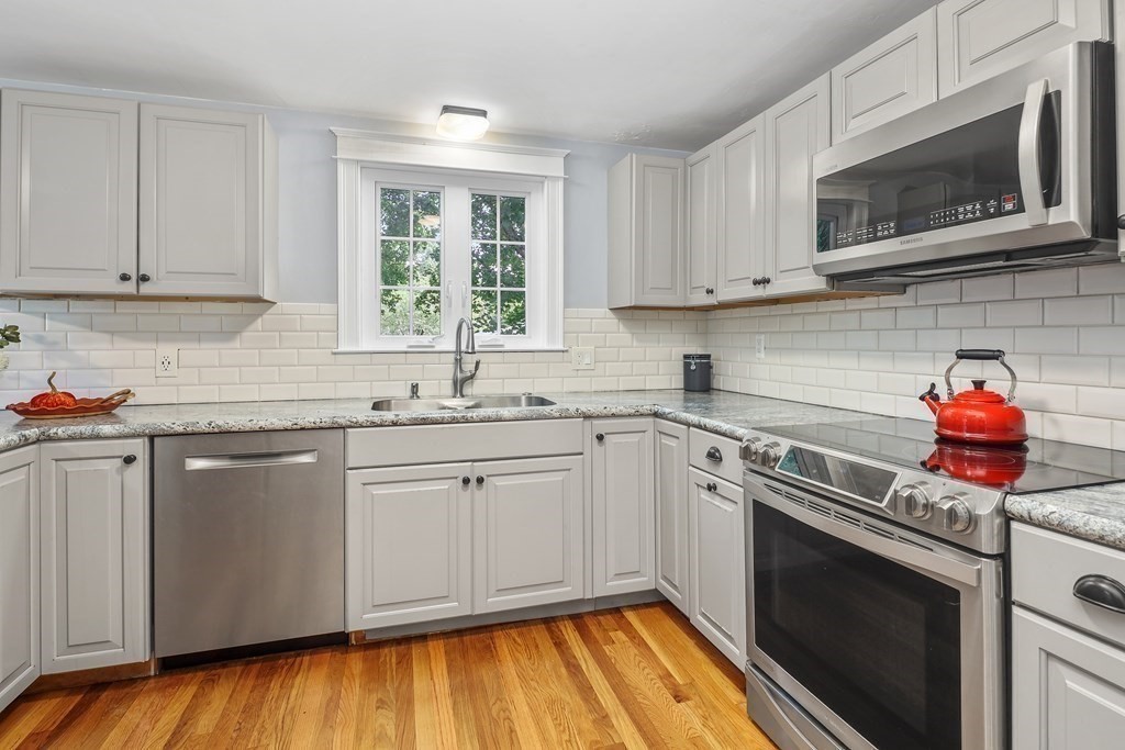 10 Colonial Road Hingham, MA 02043 - Photo 6 of 21 a kitchen with stainless steel appliances granite countertop a stove sink microwave and cabinets