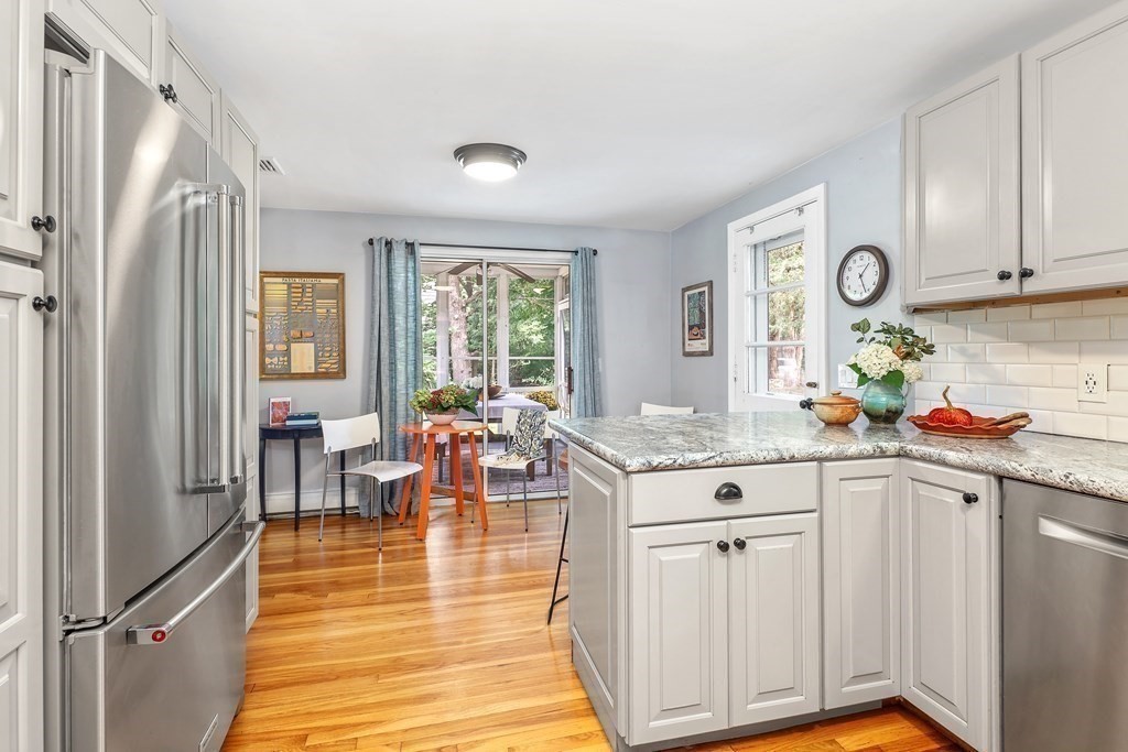 10 Colonial Road Hingham, MA 02043 - Photo 9 of 21 a kitchen with stainless steel appliances granite countertop a stove top oven a sink dishwasher and cabinets with wooden floor