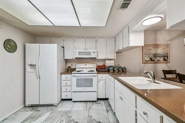a view of a dining room that has a table and chairs in it