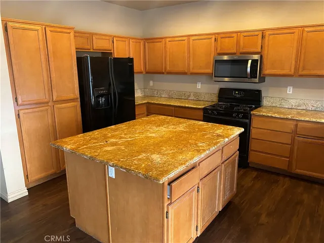 a kitchen with a appliances a sink and a refrigerator