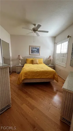a spacious bedroom with a bed and a chandelier