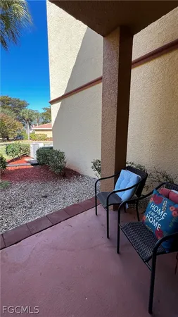 a backyard of a house with barbeque oven table and chairs