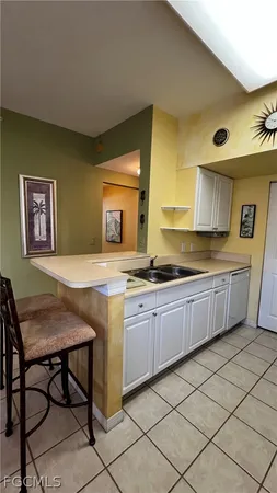 a kitchen with a sink cabinets and window